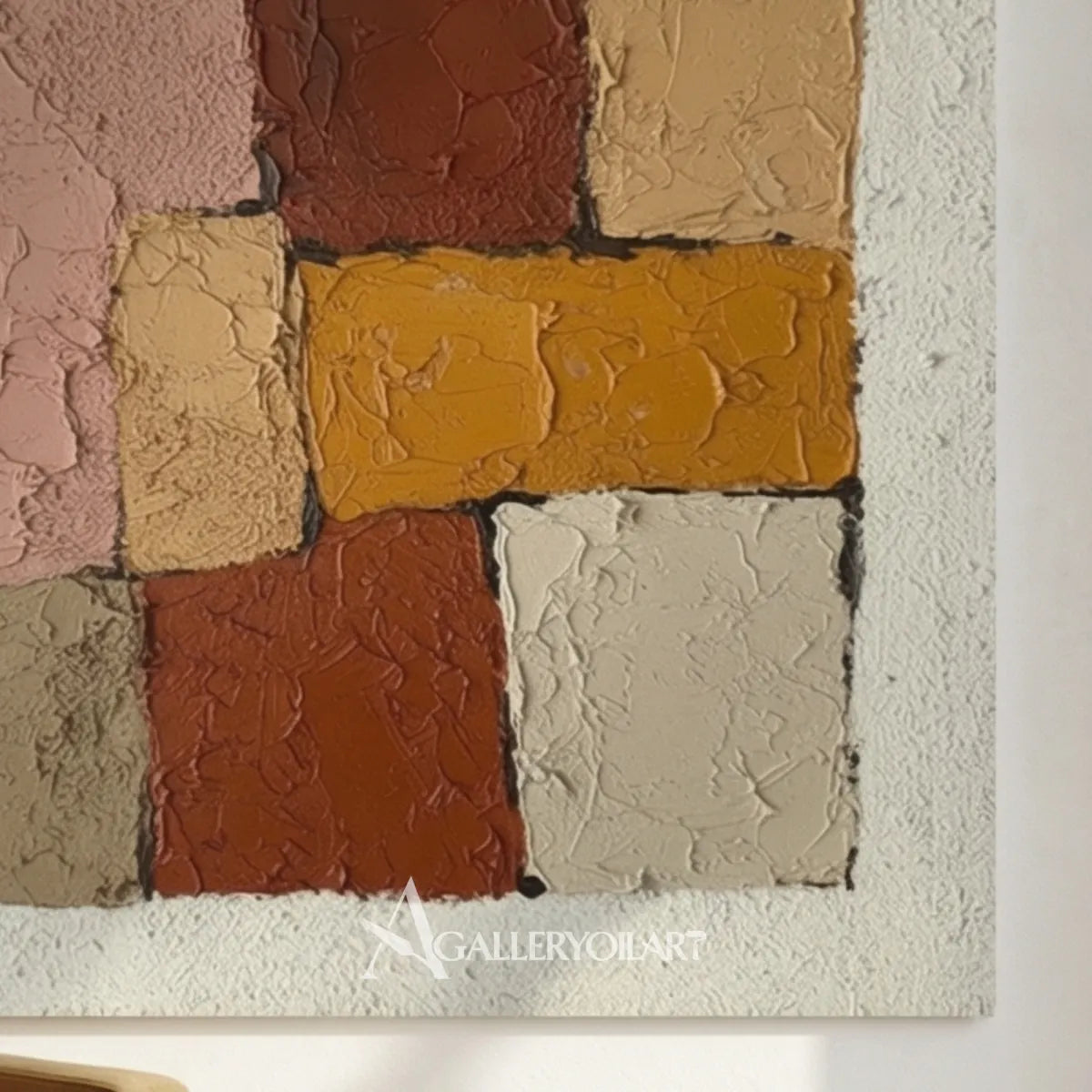 close-view-of-raised-abstract-blocks-in-dusty-pink-brown-ochre-and-cream-in-an-art-studio