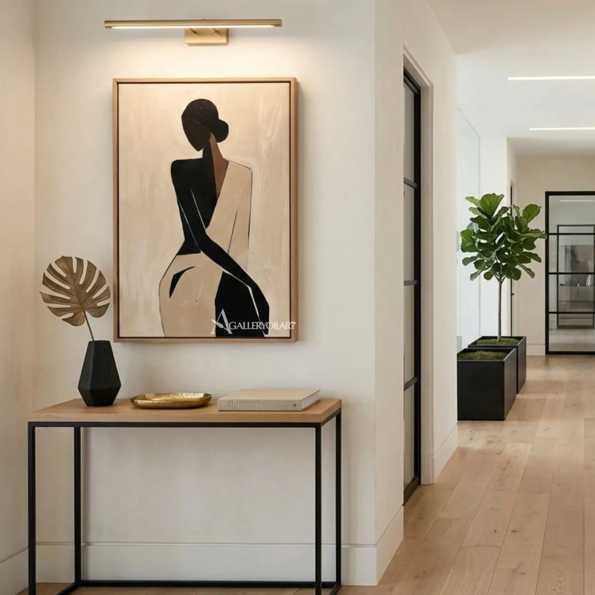 Black-silhouette-of-woman-in-flowing-dress-portrait-art-displayed-in-a-modern-entryway-with-neutral-tones