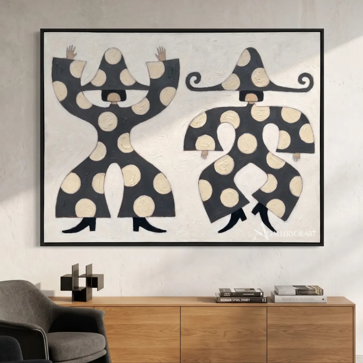 folk-art-pair-in-black-and-cream-hung-above-a-console-table