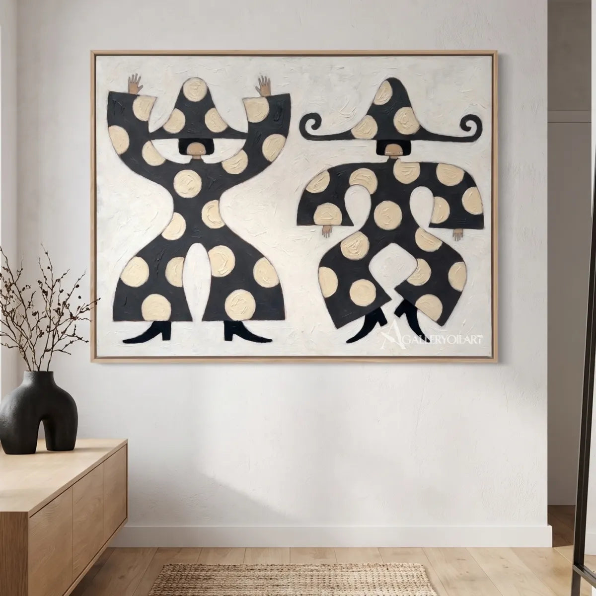 square-folk-art-figures-in-black-and-cream-against-a-light-entryway-wall