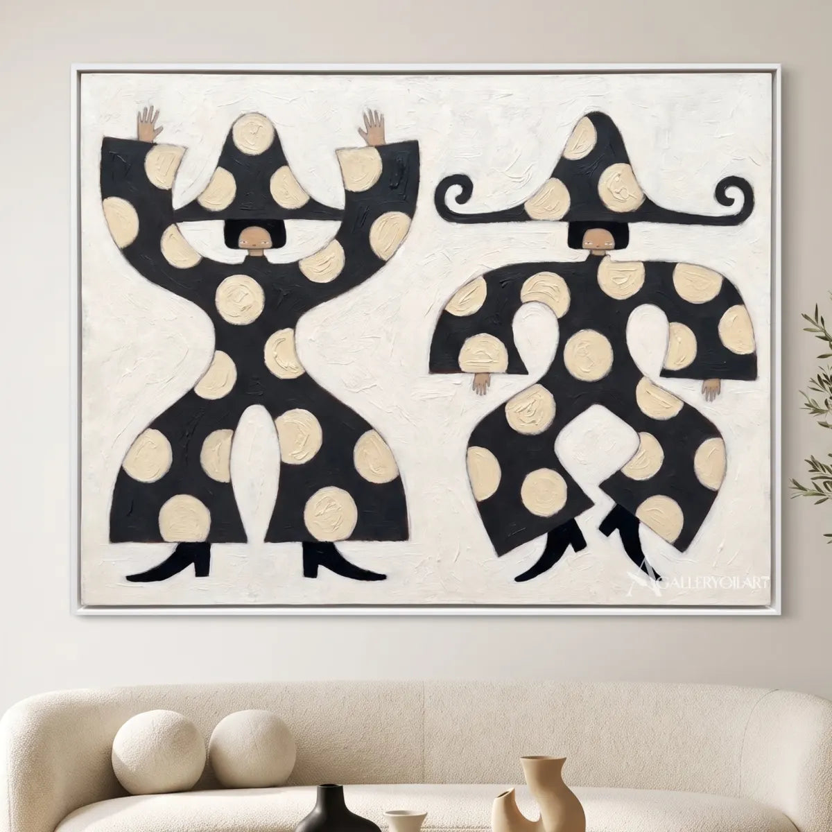 square-folk-art-figures-in-black-and-cream-above-a-living-room-sofa