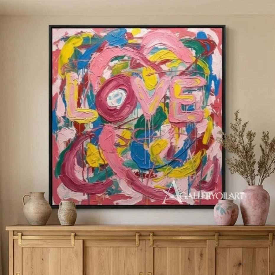 Pop art painted LOVE letters in pink, blue, yellow, green, and white wall art in lounge