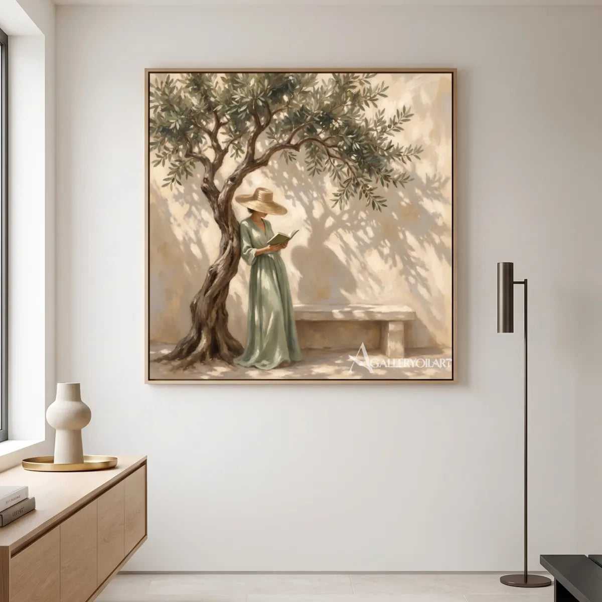 A woman reading beneath a leafy tree in square Portrait Art above a soft neutral sofa, with beige and green tones