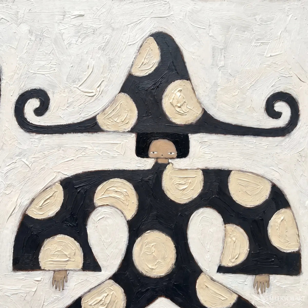 close-up-of-a-black-and-cream-folk-figure-with-a-sweeping-brim-and-dotted-dress
