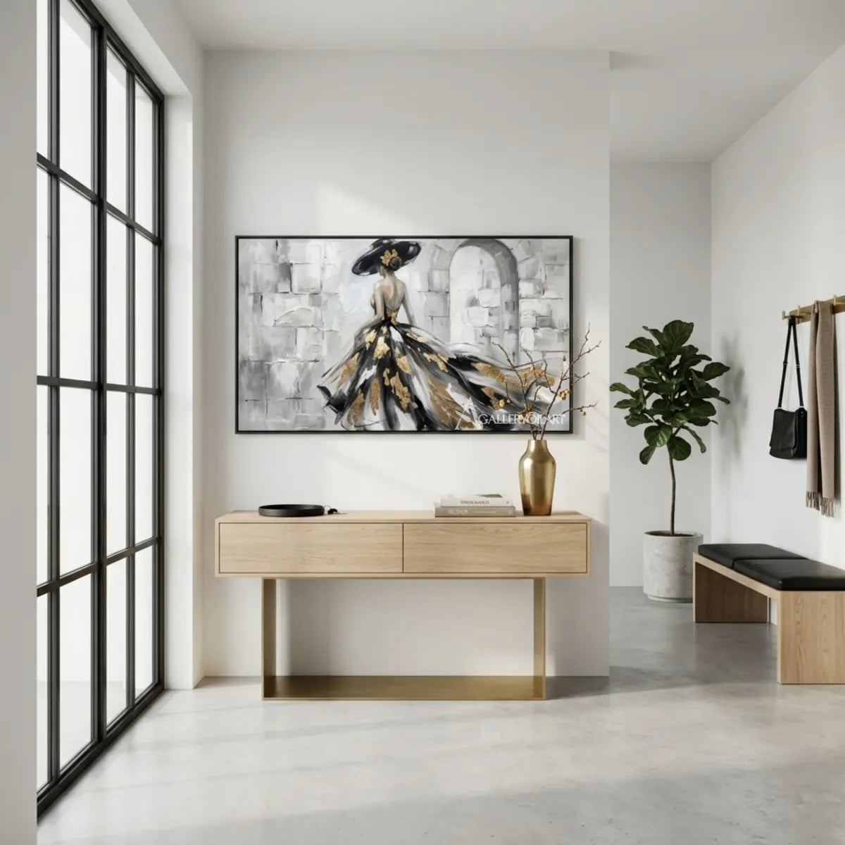 Woman-in-a-flowing-black-and-gold-gown-portrait-art-displayed-in-a-modern-entryway-with-monochrome-tones