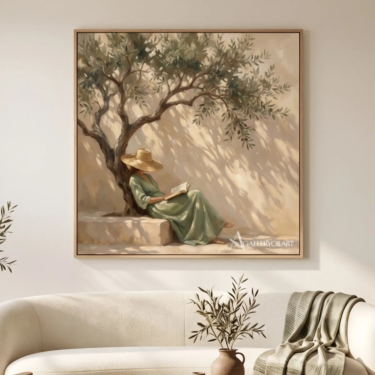 A seated woman reads beneath an olive tree in square Portrait Art above a cream sofa, with beige and sage tones