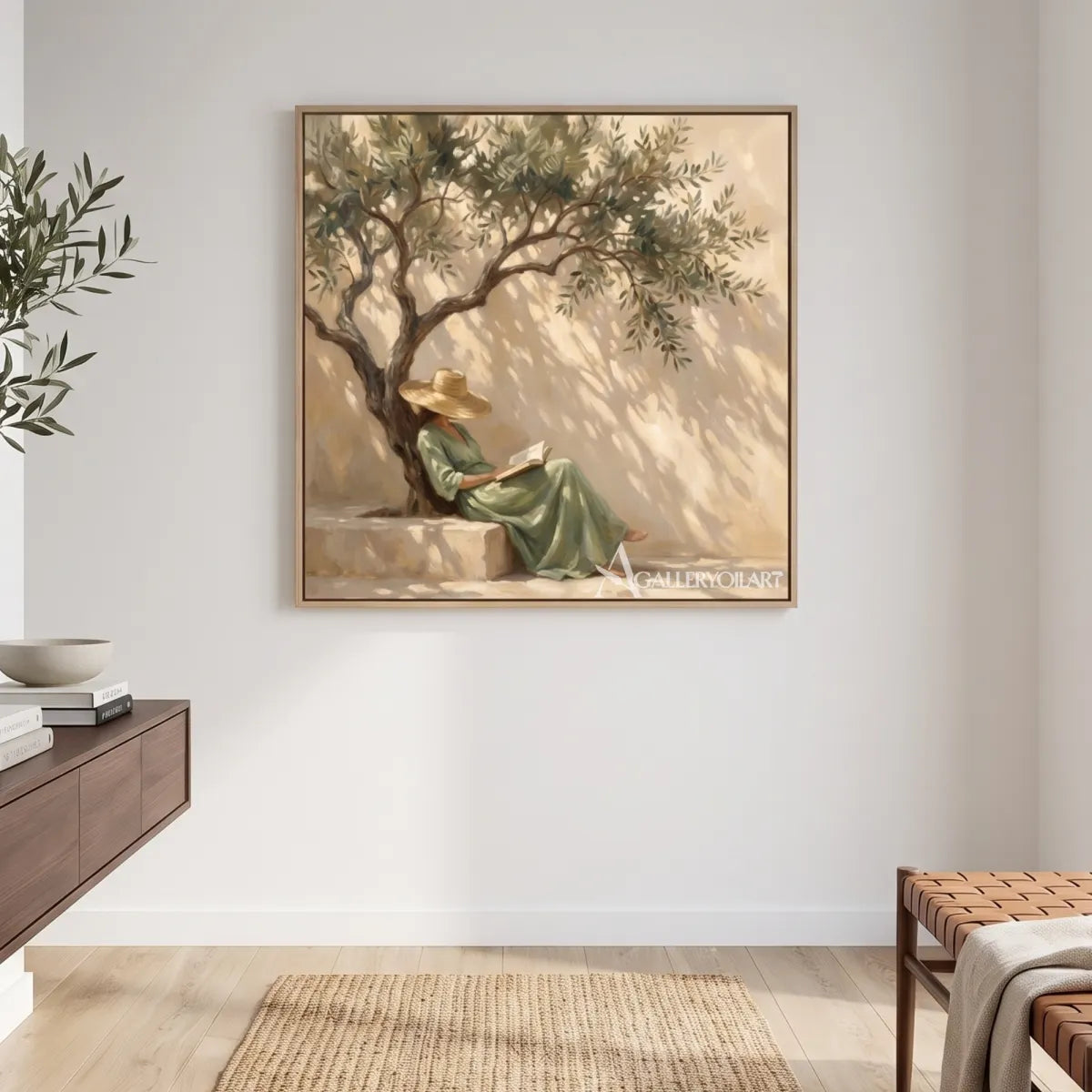 A reader in dappled shade beneath an olive tree in square Portrait Art above a wood console, with beige and sage tones