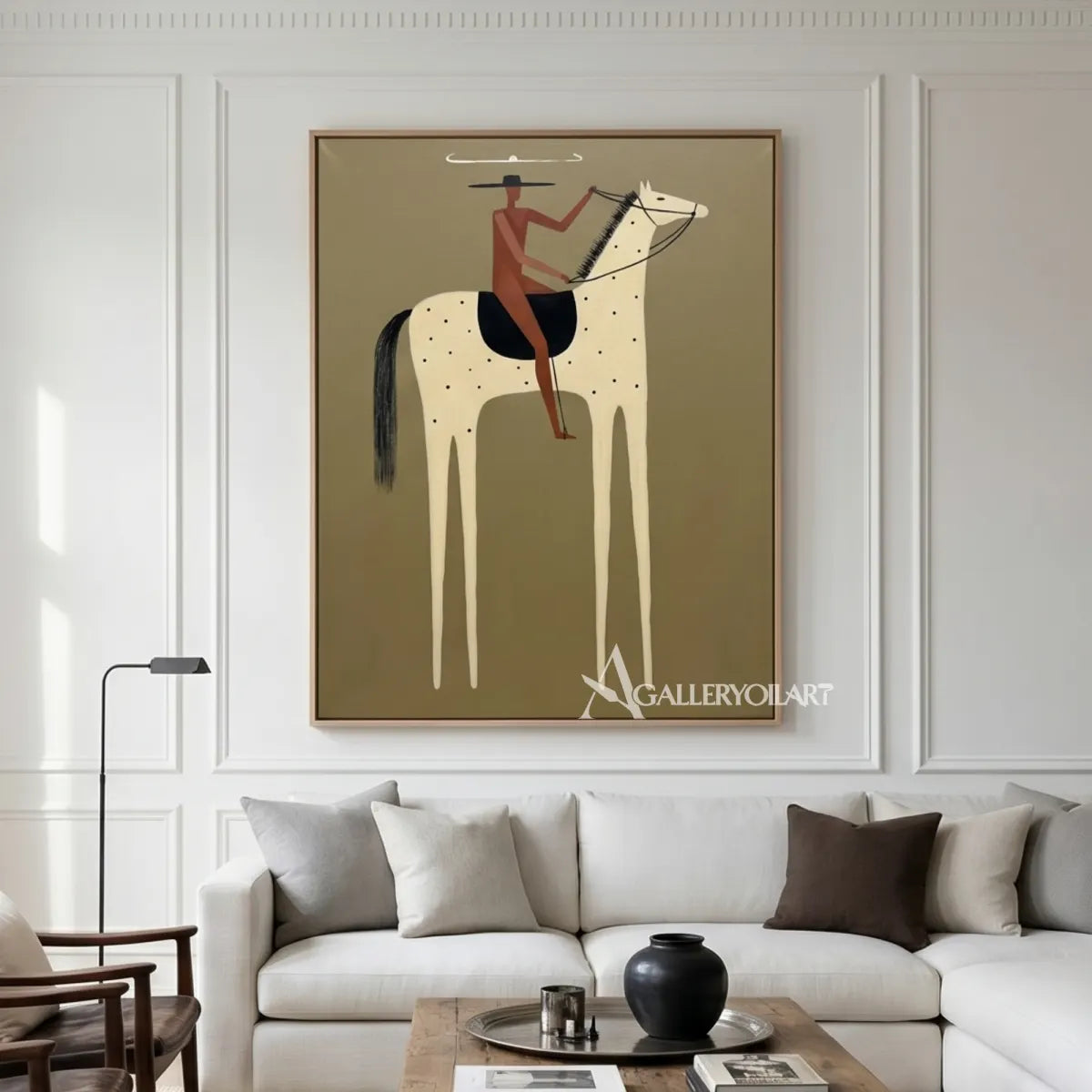 Western-cowboy-art-of-a-rust-clad-rider-on-a-spotted-cream-horse-against-an-olive-green-ground-above-a-sofa
