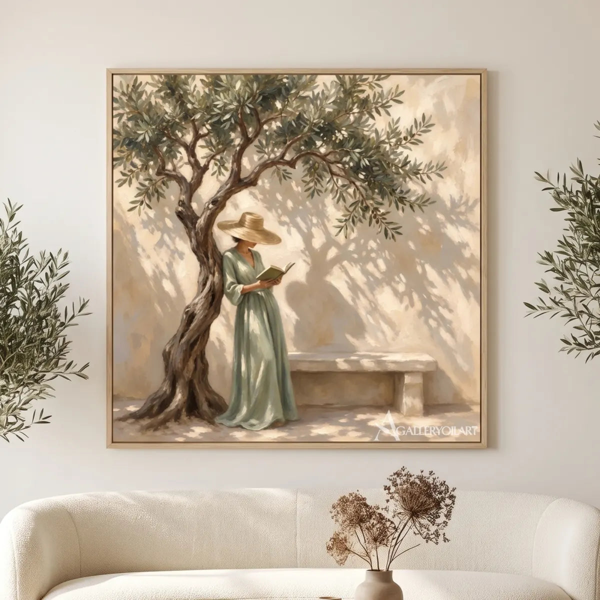 A woman reading beneath a leafy tree in square Portrait Art above a cream sofa, with beige and green tones